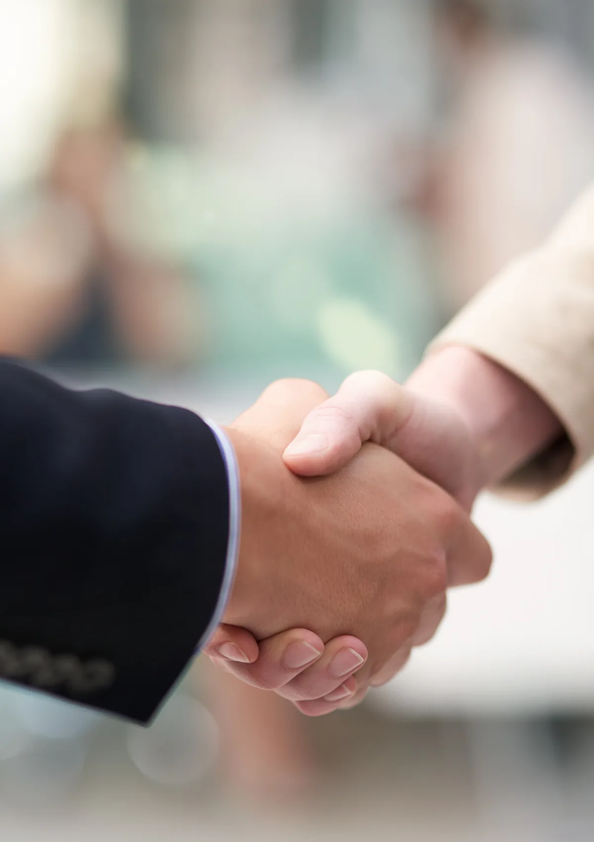 Closeup of two people shaking hands.